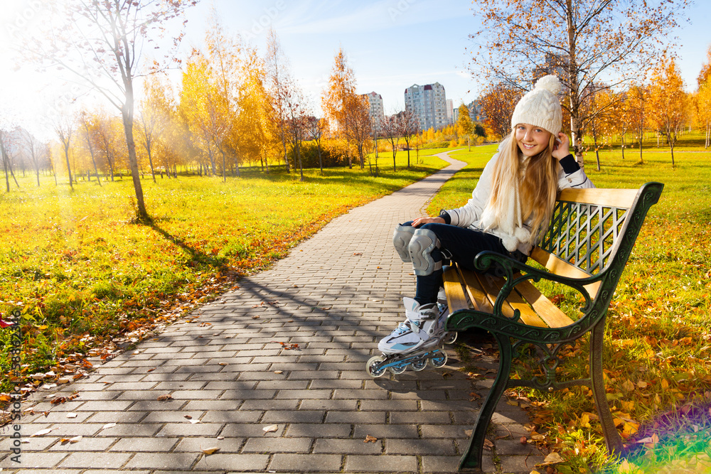 Girl on the bench with roller blades