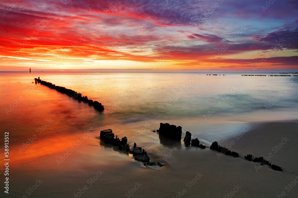 Poland, Ocean sunset on beach.