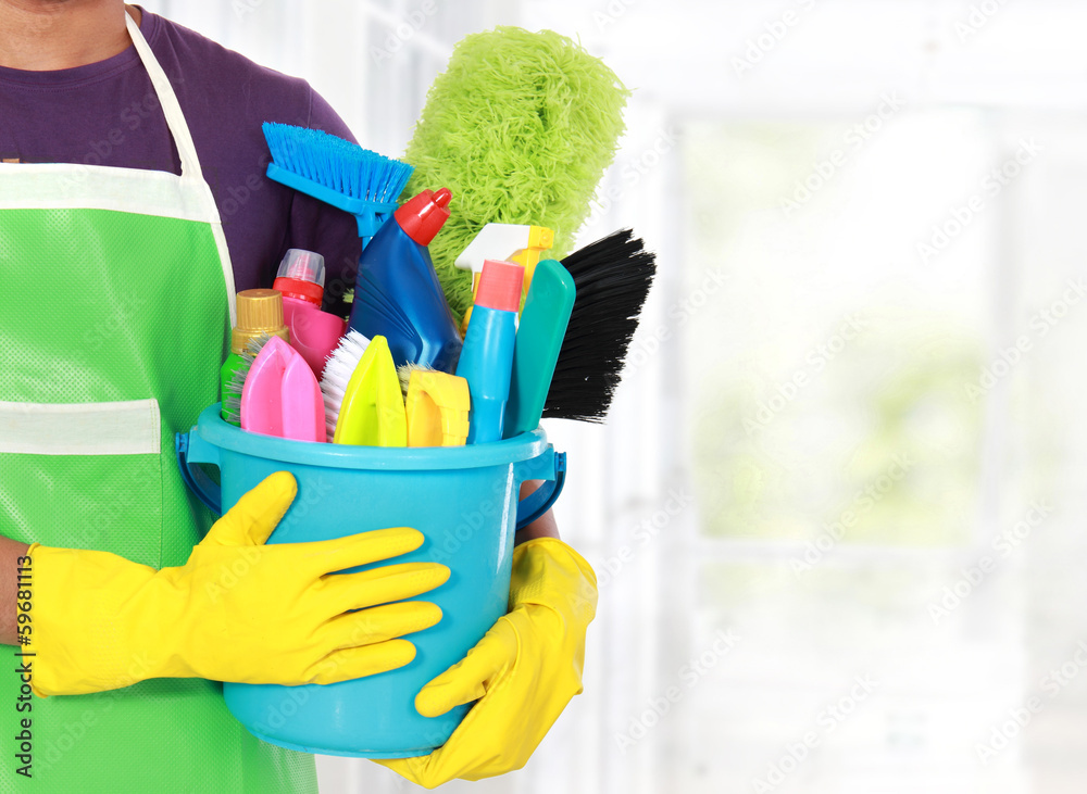 Portrait of young man with cleaning equipment