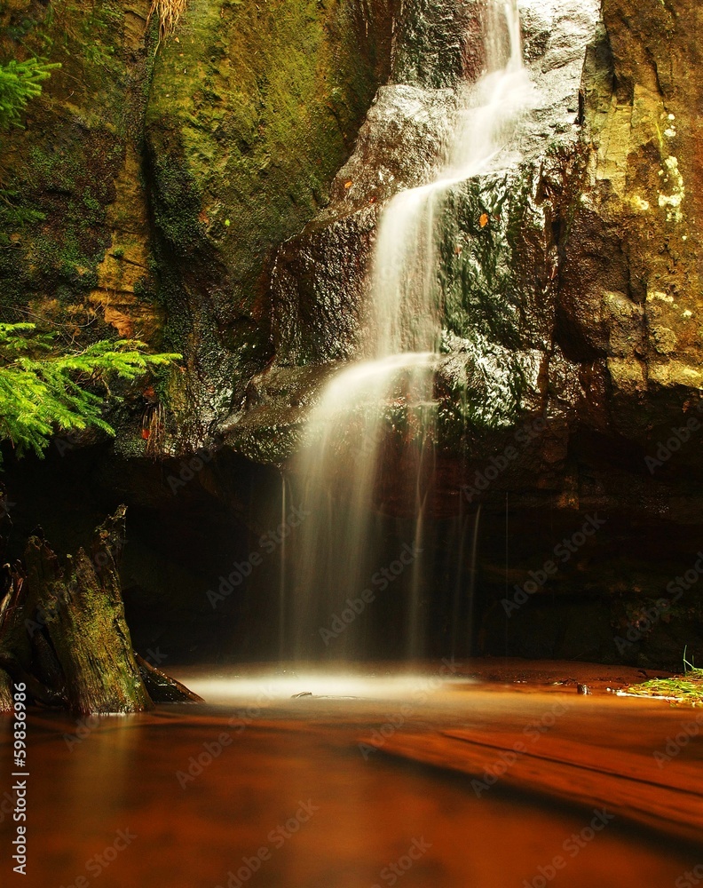 Small waterfall  on fresh stream, water  run over mossy  block