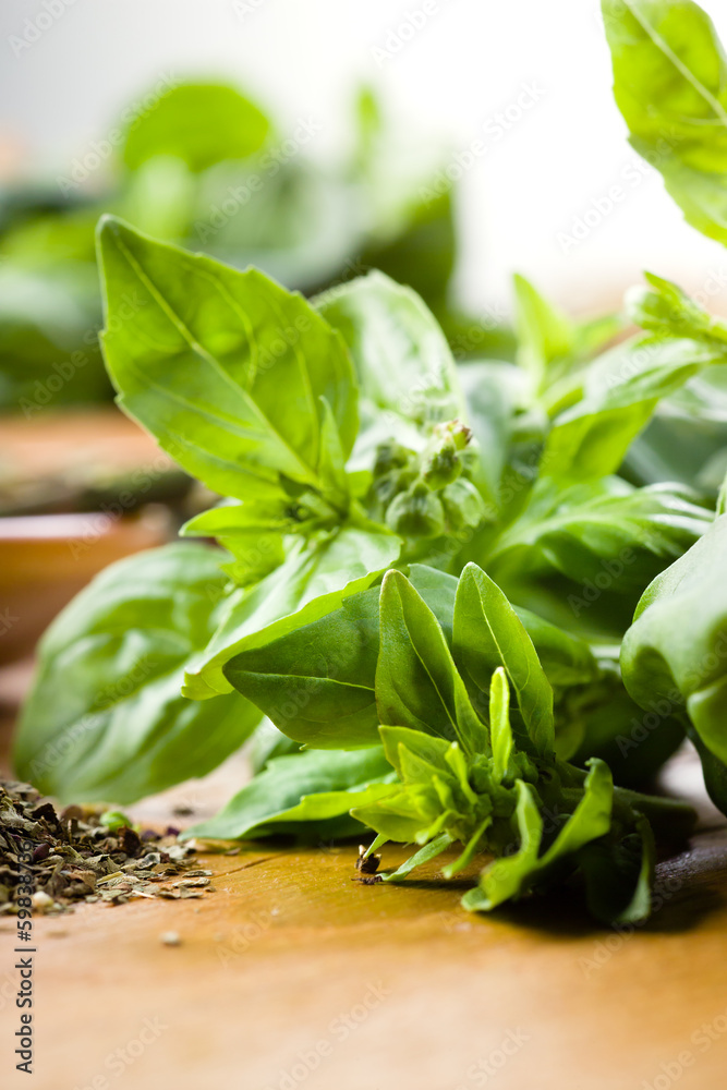 Basil leaves on a wooden table