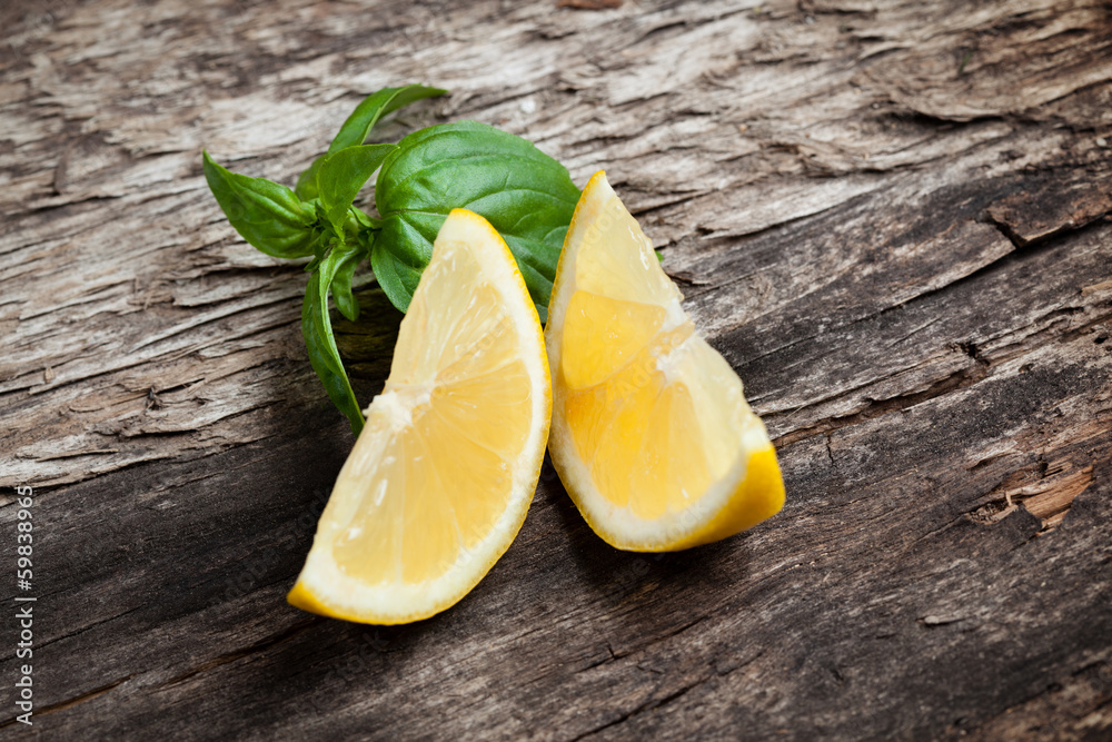 Lemon. Fruit pieces on wooden table. Organic food