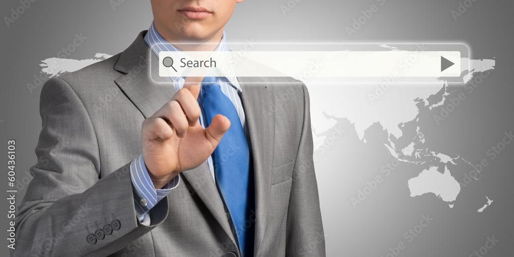 Businessman pushing on a touch screen