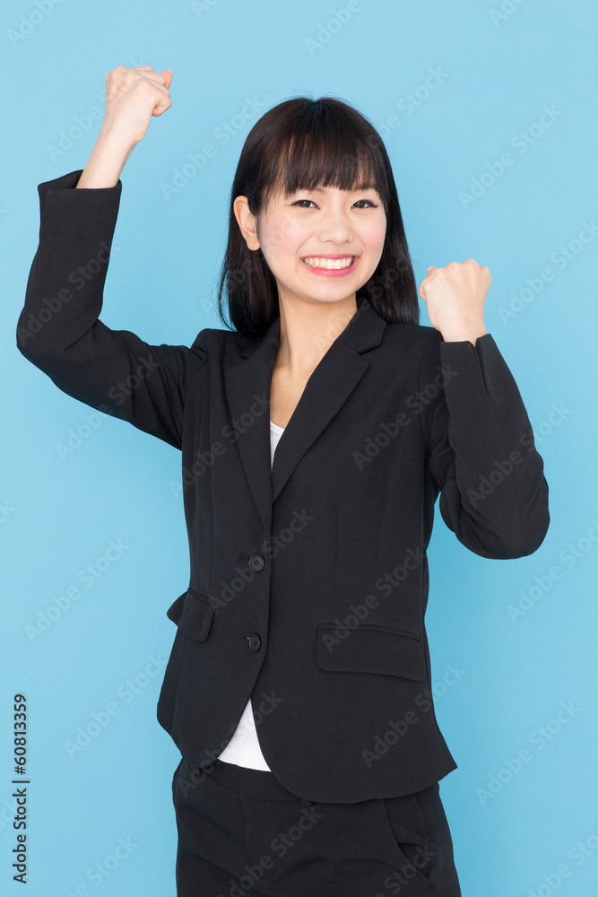 asian businesswoman cheering on blue background