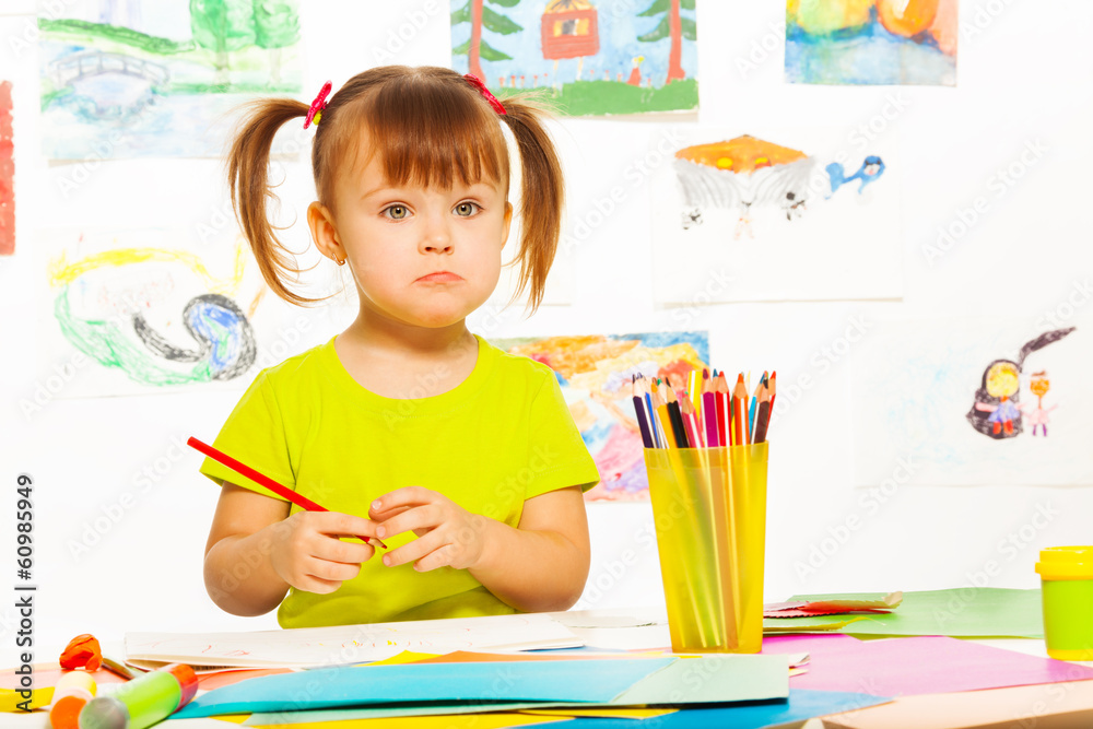 Sad little girl with pencil