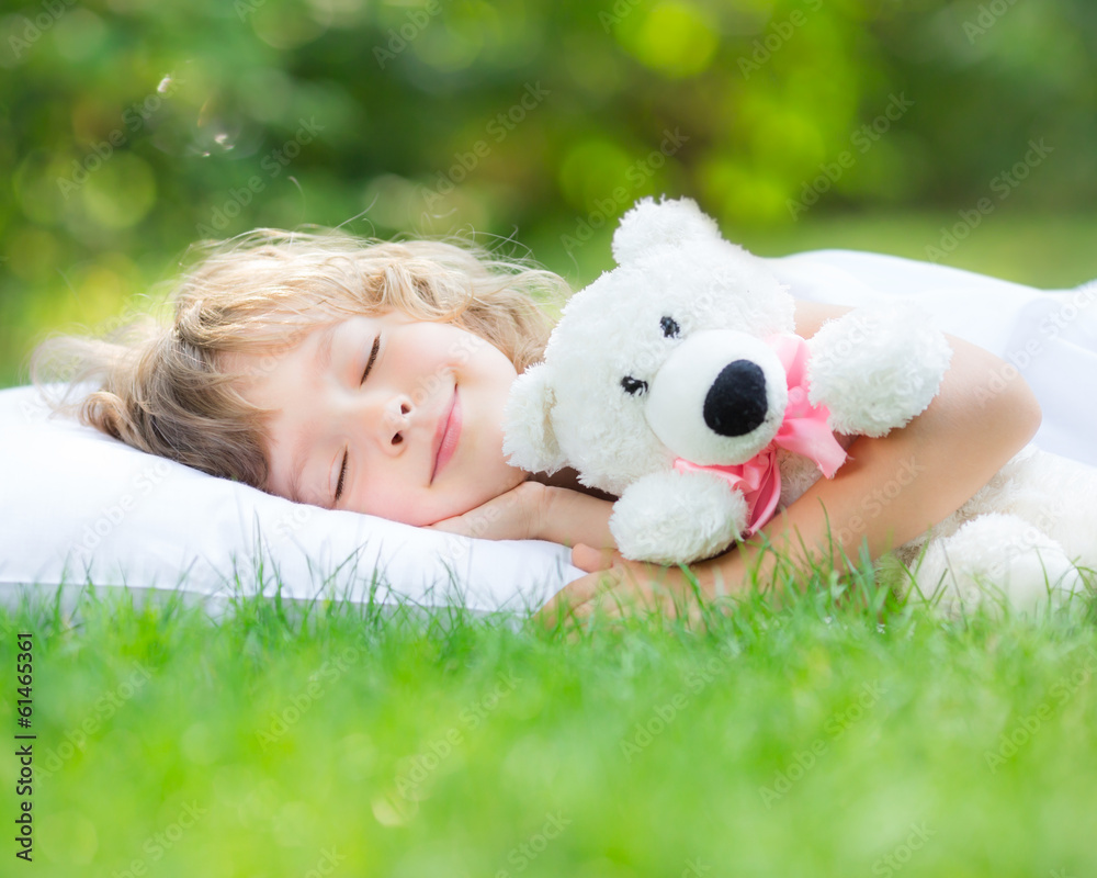 Child sleeping in spring garden