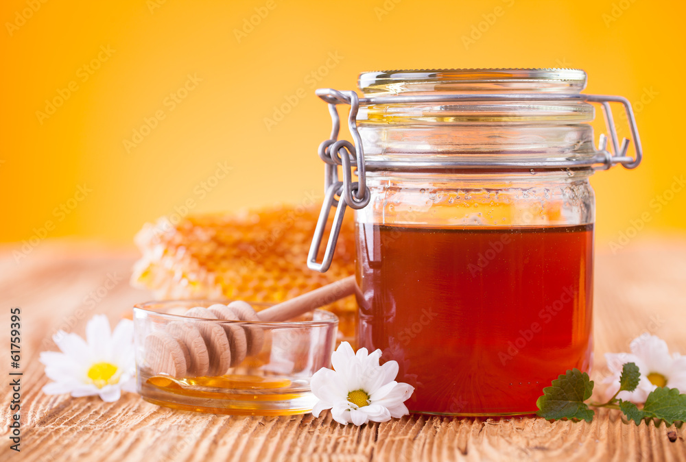 Still life of honey on wooden table