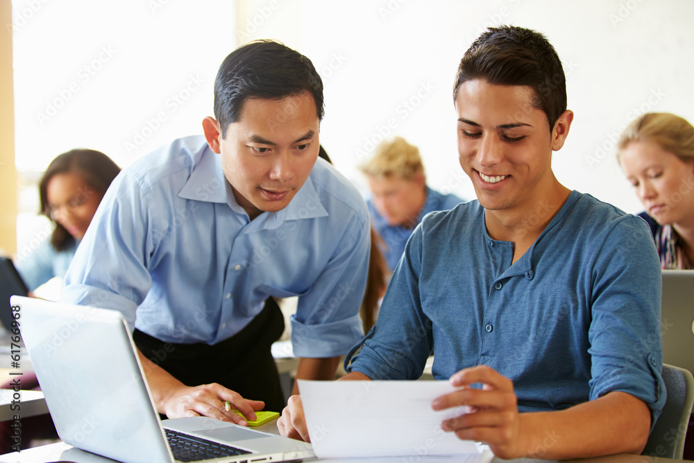 High School Students With Teacher In Class Using Laptops