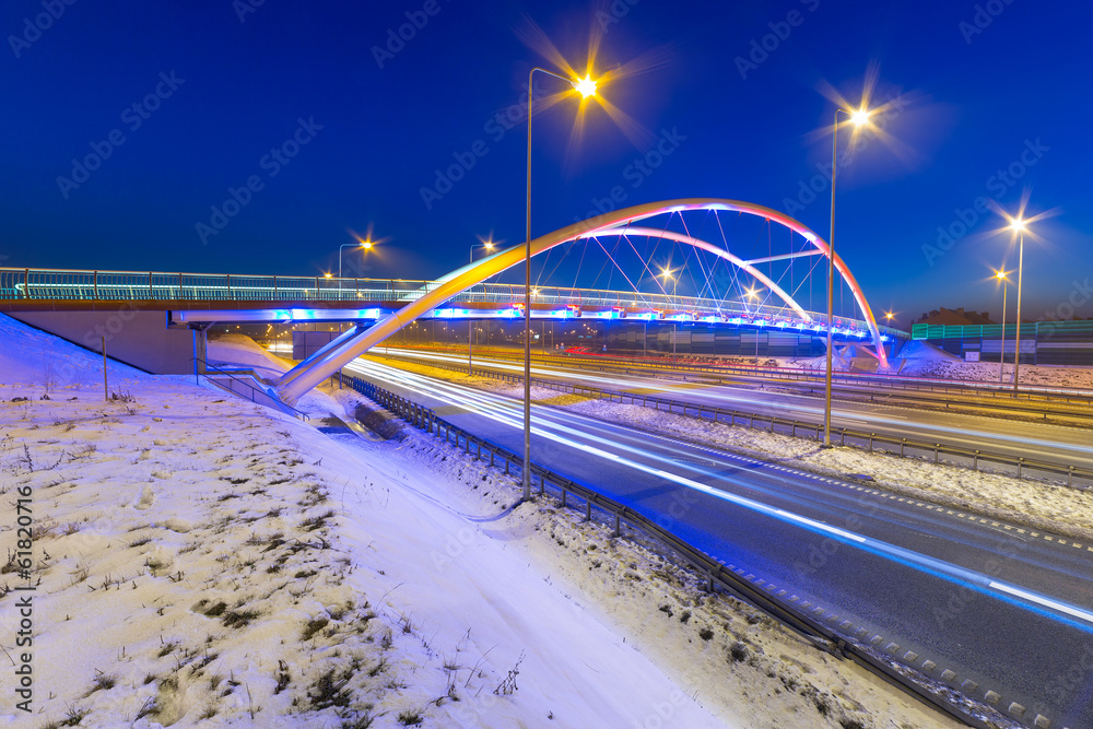 Foothpath bridge over bypass of Gdansk at night, Poland