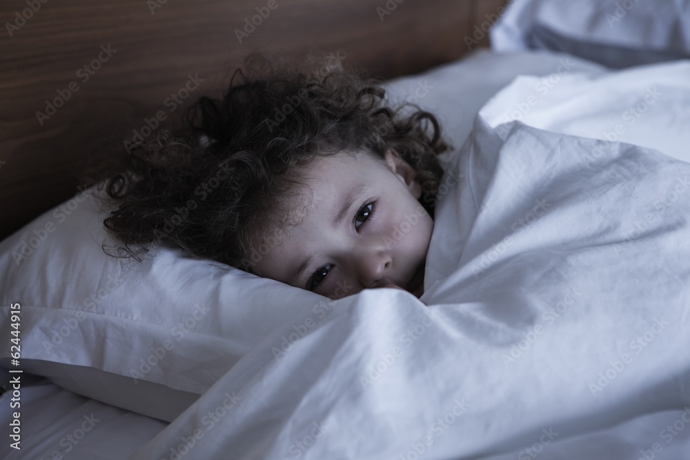 Close-up portrait of a girl resting in bed