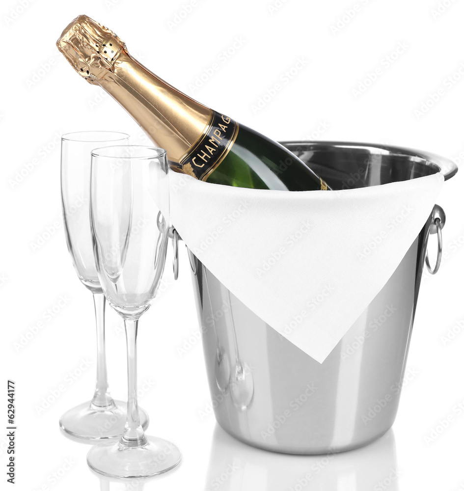 Bottle of champagne in pail and empty glasses, isolated on