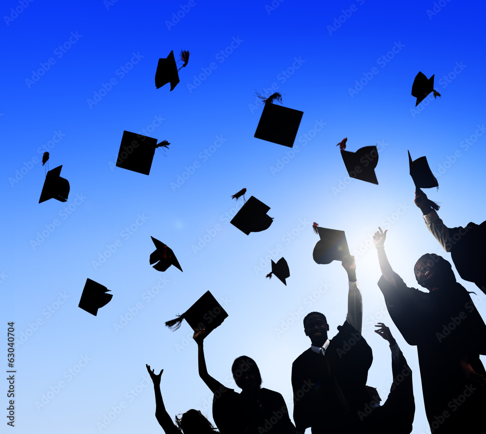 Silhouette of Graduating Students Throwing Caps In The Air