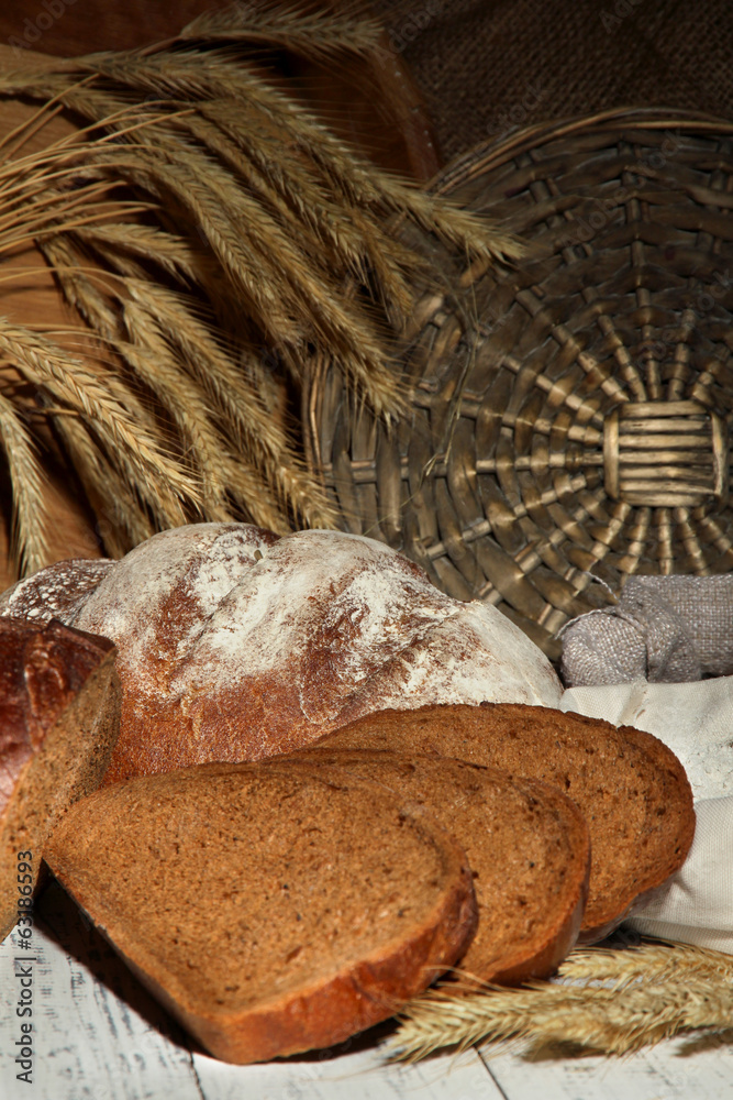 Composition with rye bread on table on wicker background