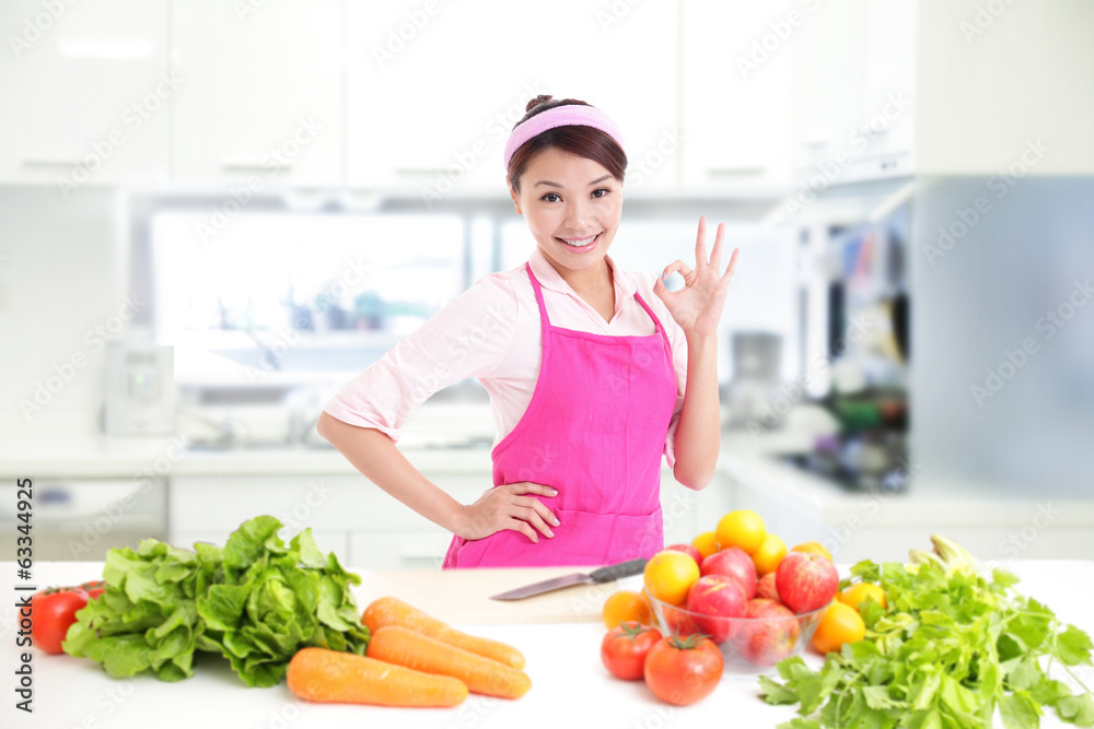 Happy smiling woman in kitchen