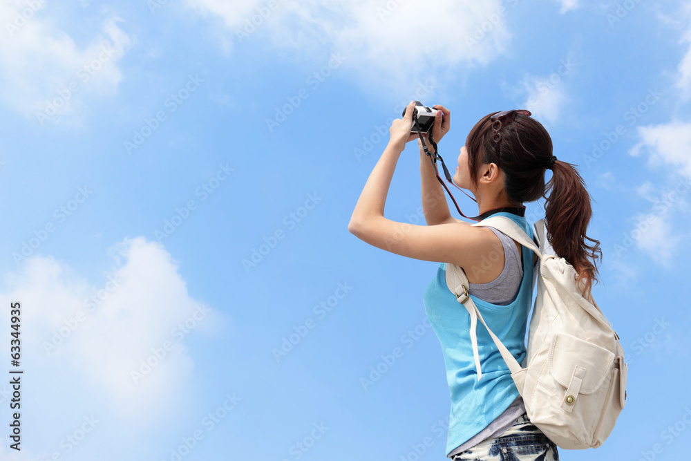 Happy woman traveler photo by camera