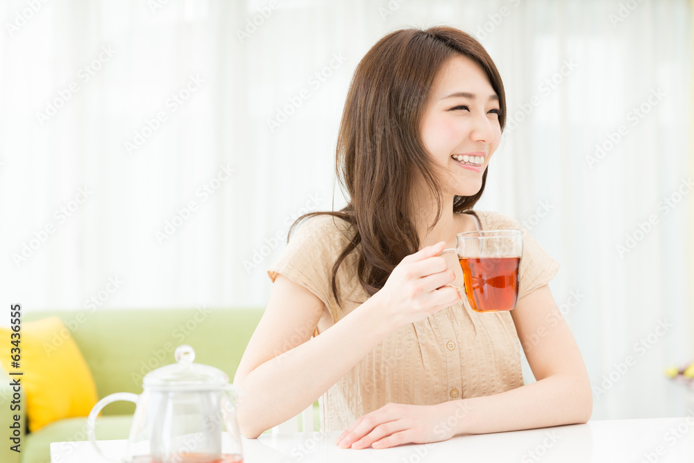 部屋でお茶を飲む女性