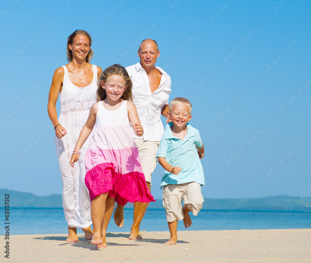 Family running on the beach