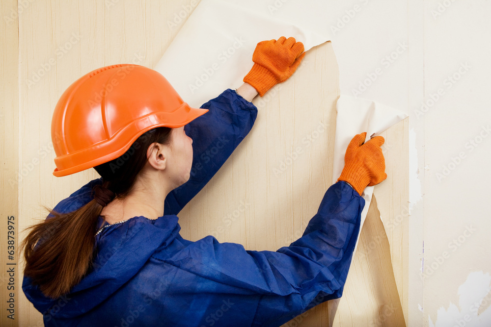 worker removes old wallpaper