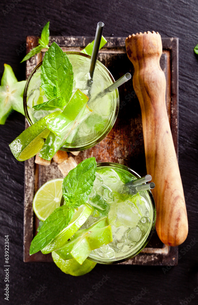 Fresh mojito drinks on stone surface