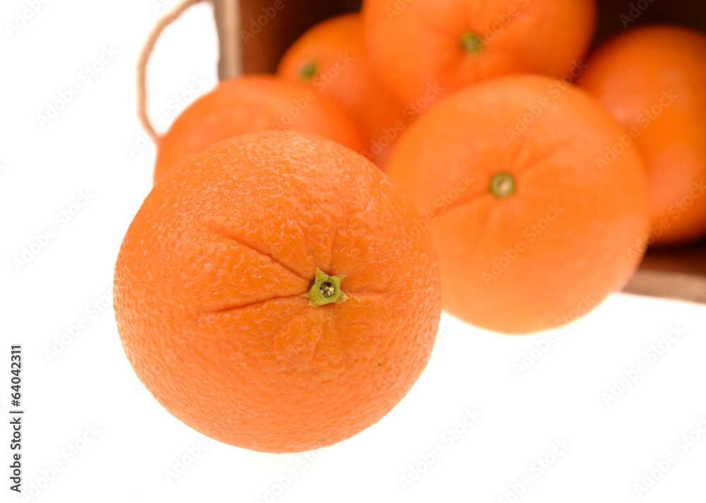 Ripe tasty tangerines with leaves in wooden box