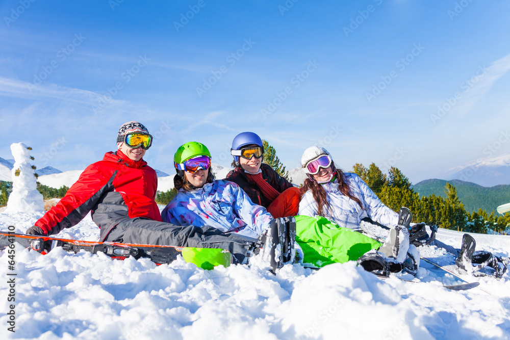 Four happy smiling friends wearing goggles