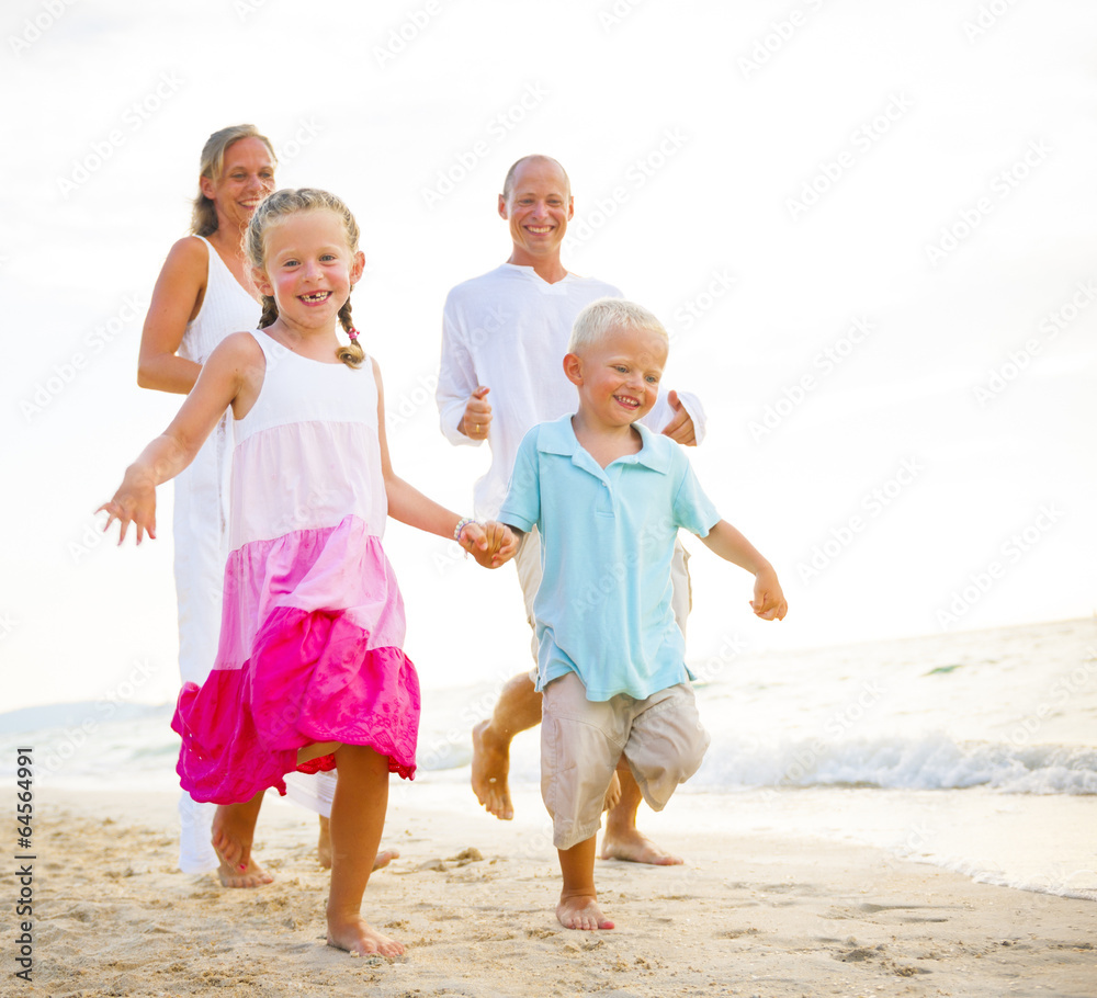 Family running on the beach