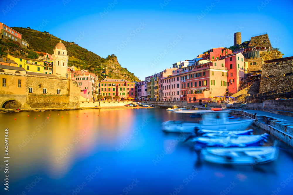 Vernazza village, church, boats and sea harbor on sunset. Cinque