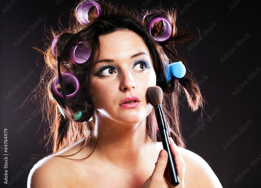 Woman makeup, hair with curlers and cosmetic brush