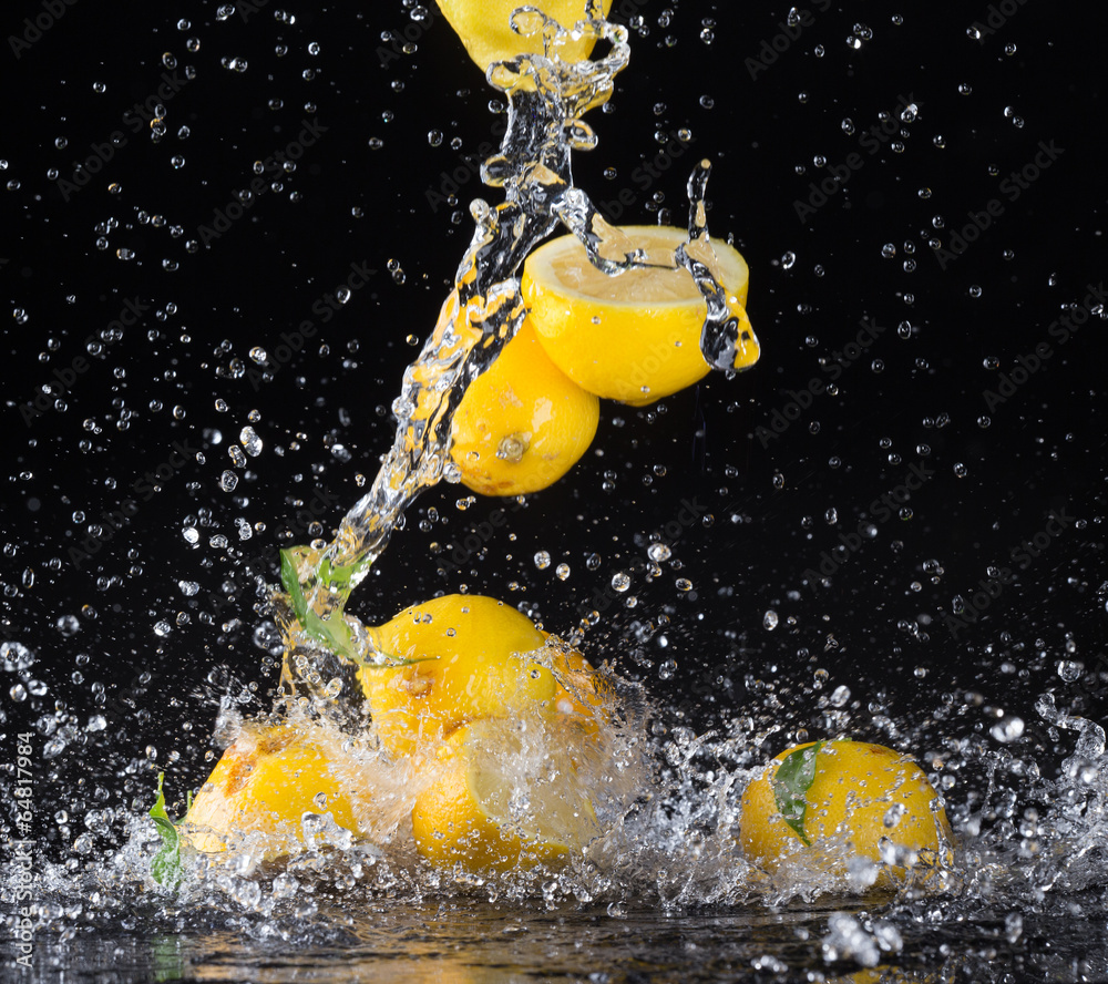 Lemons in water splash on black background