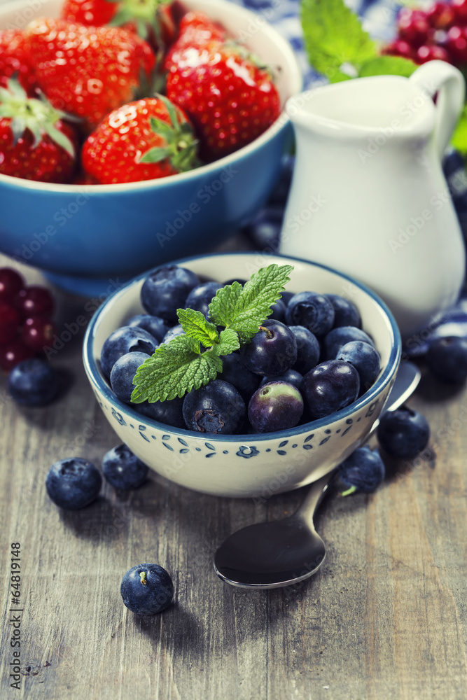 Berries in bowls  on Wooden Background.