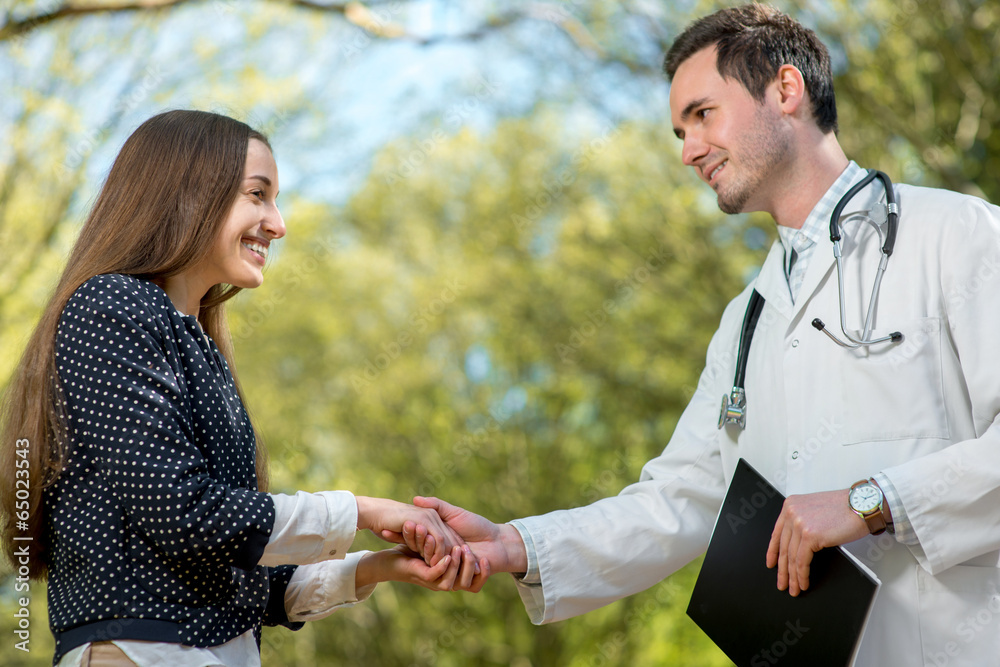 Handshake of a doctor and patient or assistant