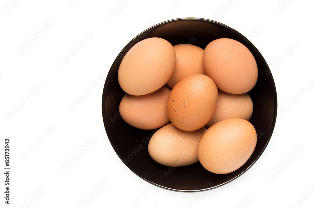 Eggs in the black bowl on isolated background