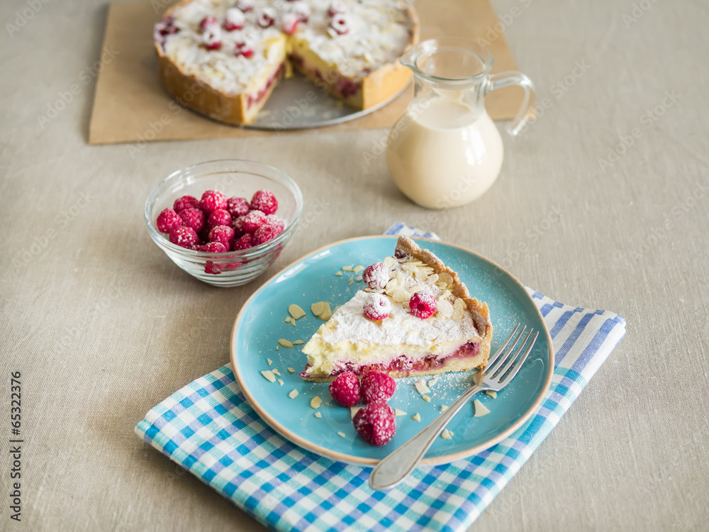 A piece of mascarpone pie with fresh raspberris and milk