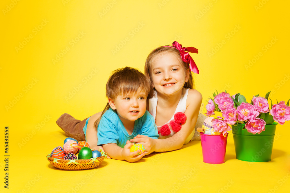 Smiling girl with small child lying on the floor