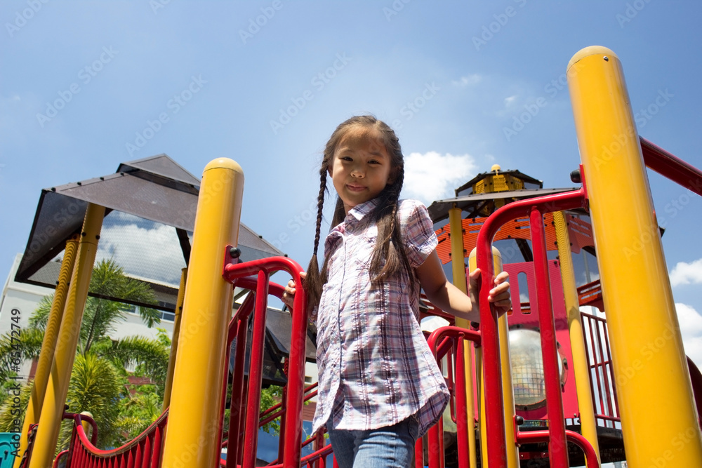 Cute beautiful smiling little girl on a playground