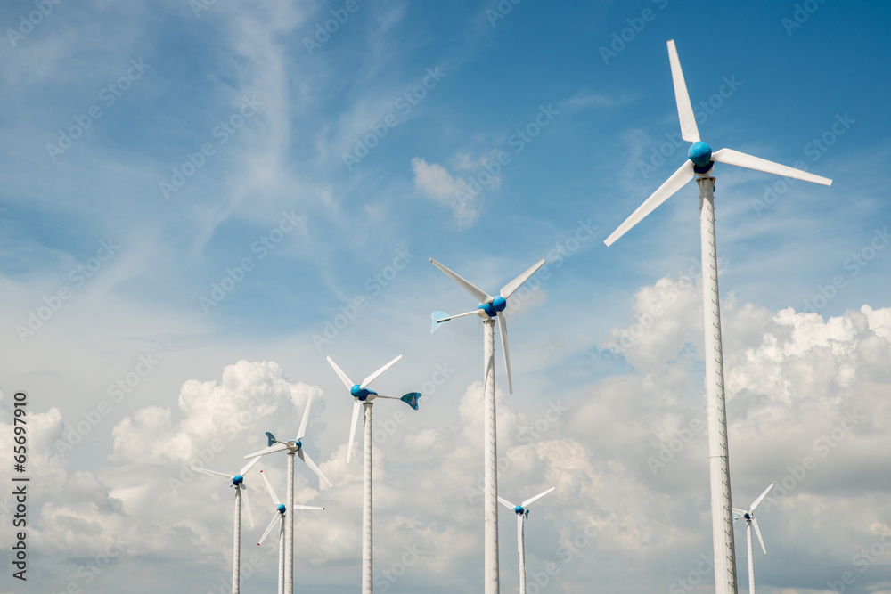 Wind mill power plant against blue sky