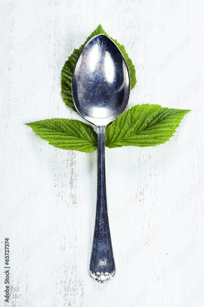 Spoon with fresh leaves. Health, diet, vegetarian food concept