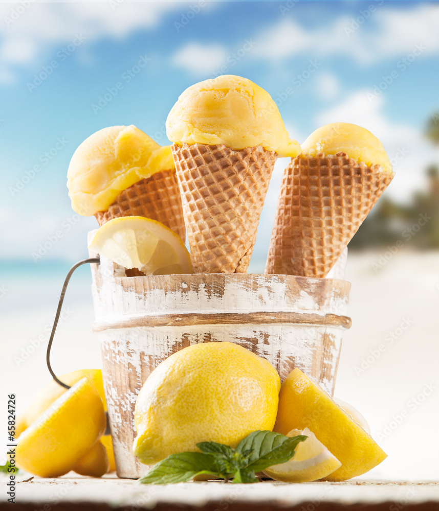 Lemon cce cream scoops in cones with blur beach