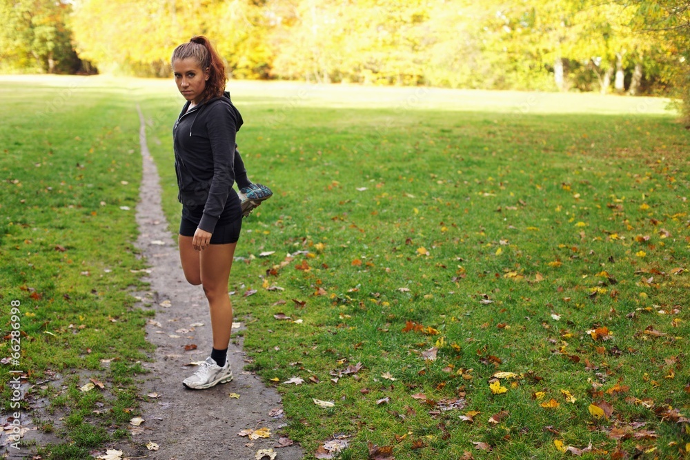 Beautiful female stretches before her workout