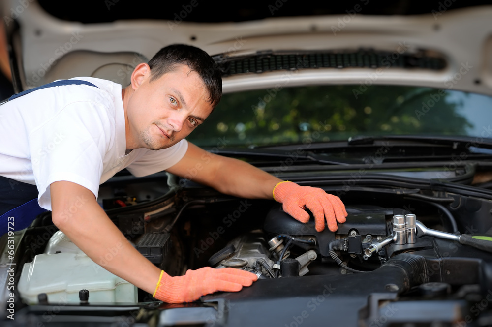 Car mechanic in auto repair service