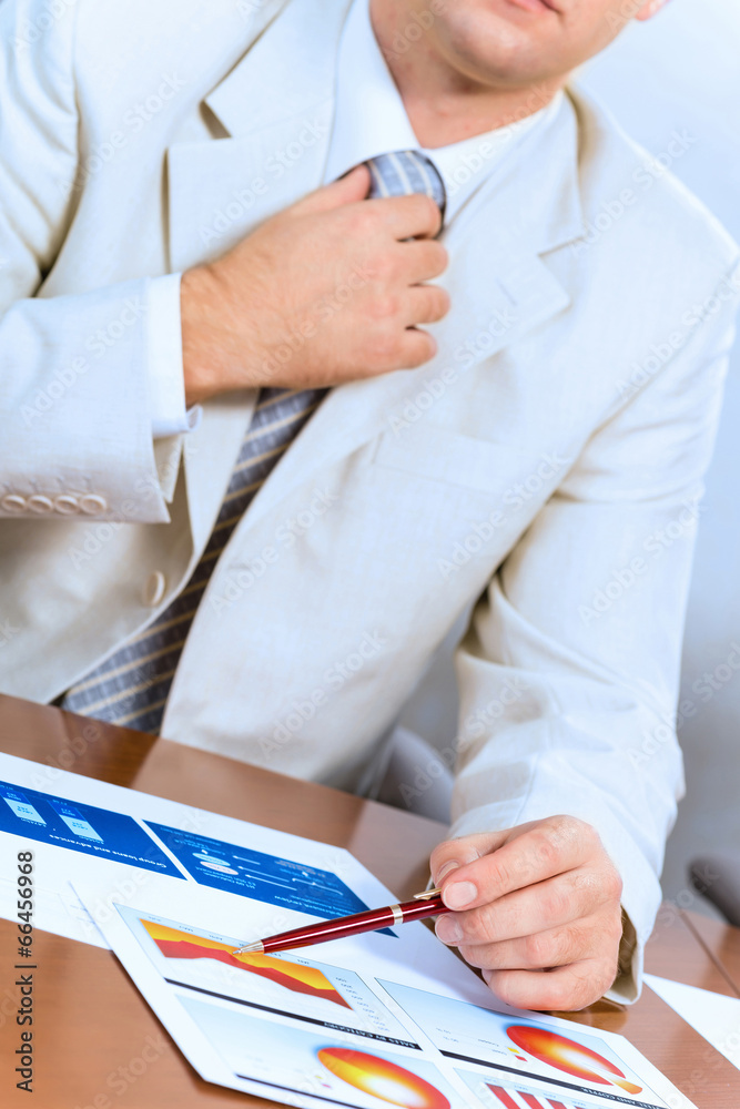 businessman corrects a tie themselves