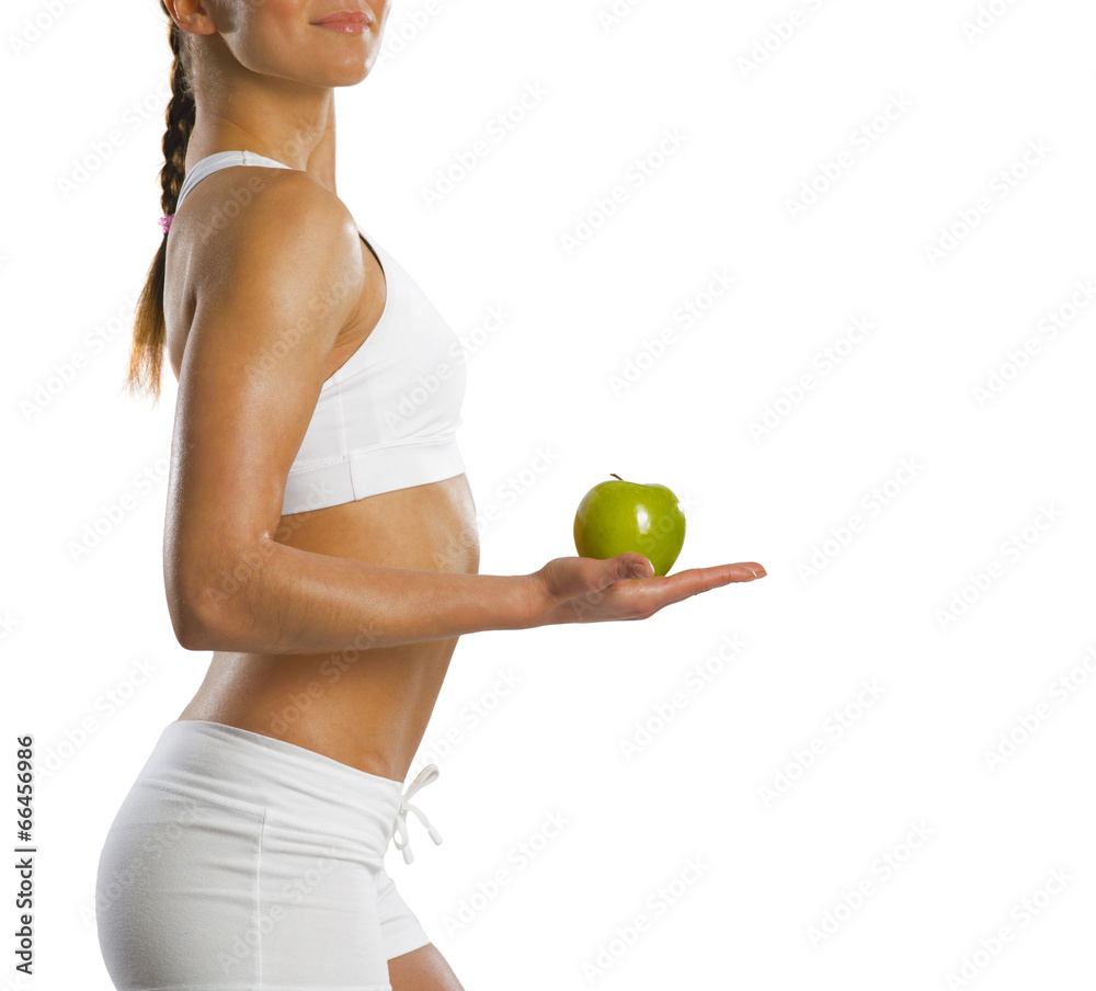 young attractive sporty woman with green apple