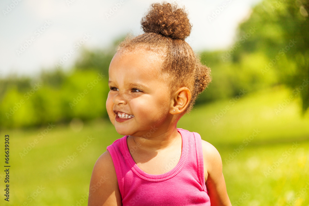 Laughing small girl on the nature background