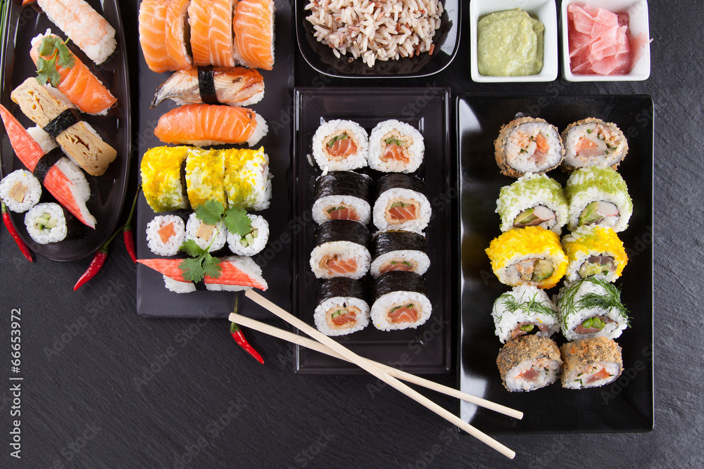 Delicious sushi pieces served on black stone