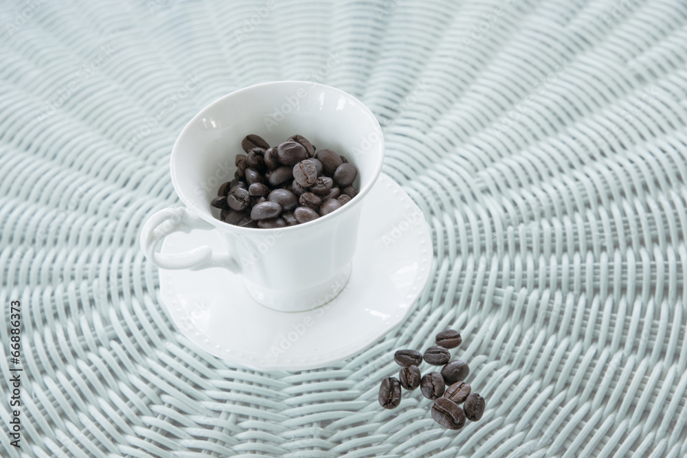 Coffee beans and coffee cup on table