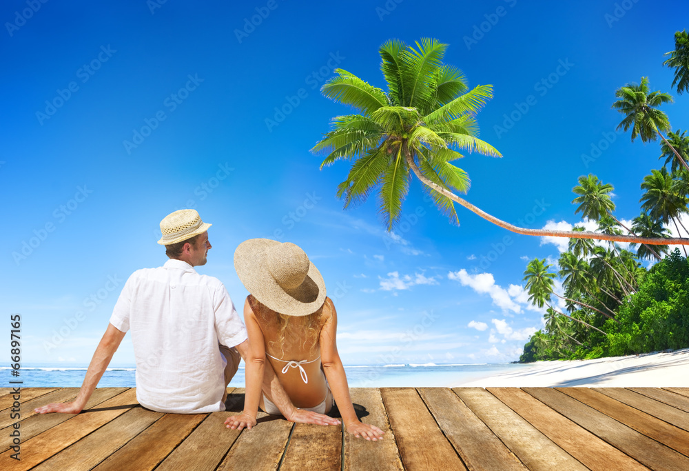 Couple Sitting on Wooden Floor at Beach