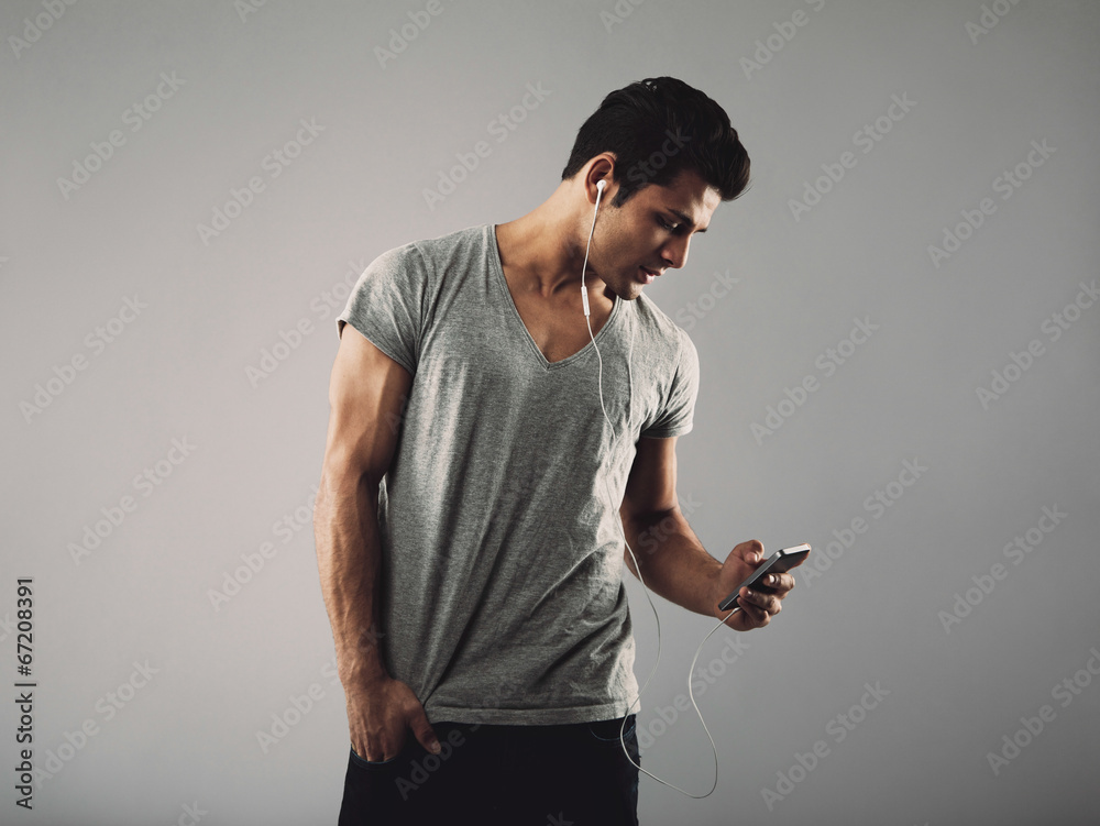 Handsome young man listening music on cell phone