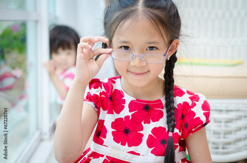 Little beautiful asian girl with glasses