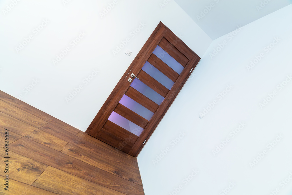 Empty apartment interior with wooden floor after renovation