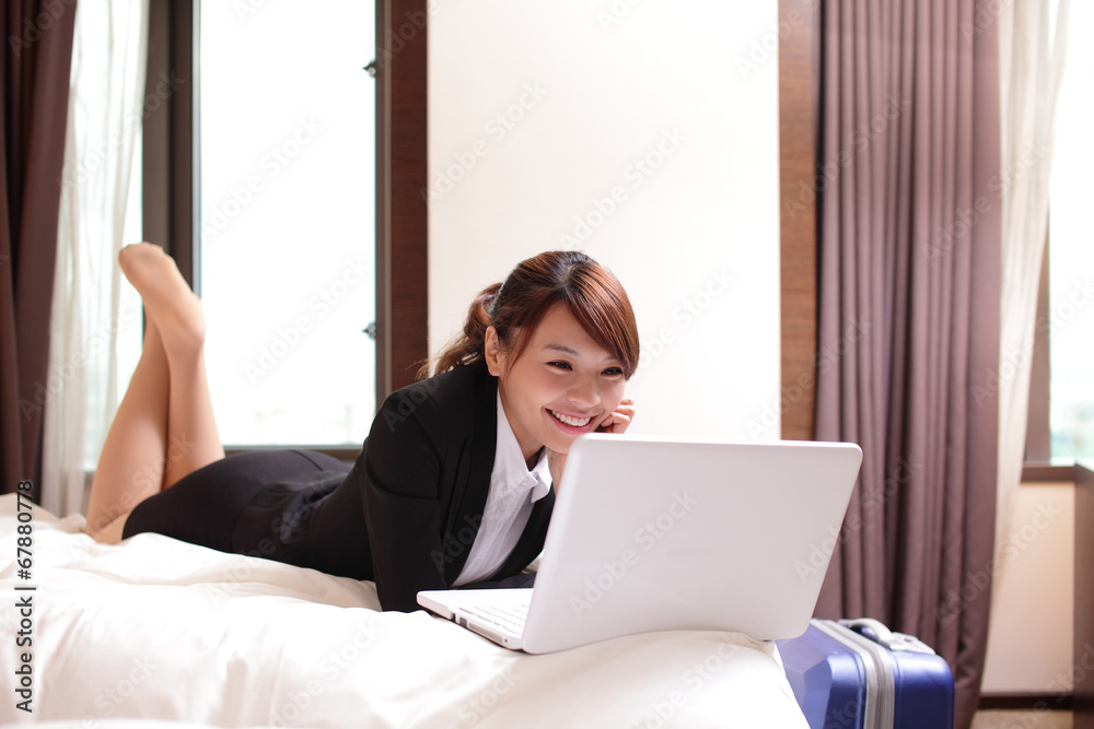 business woman with notebook lying in hotel